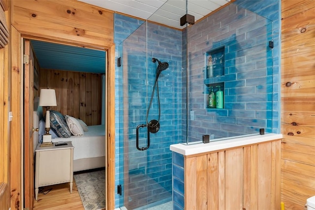 bathroom featuring wood-type flooring and an enclosed shower