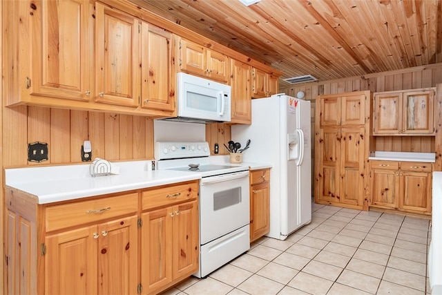 kitchen with light tile patterned flooring, wooden walls, wood ceiling, and white appliances