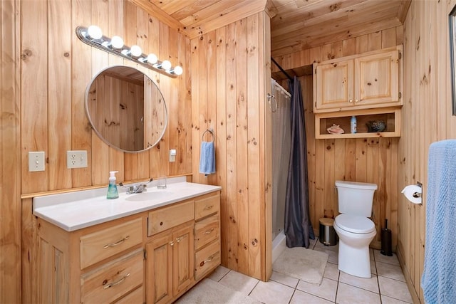 bathroom with vanity, wooden walls, tile patterned floors, and toilet