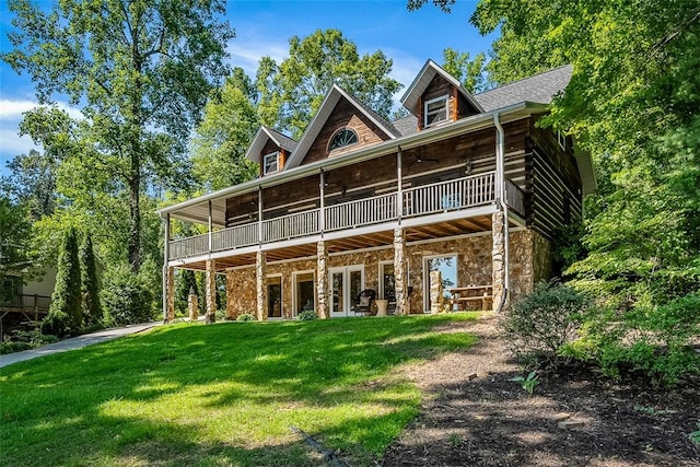 back of house featuring a wooden deck, a yard, and ceiling fan