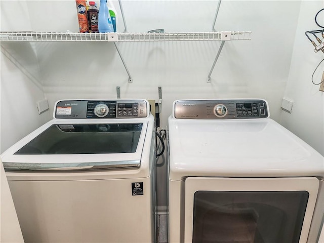 clothes washing area with independent washer and dryer