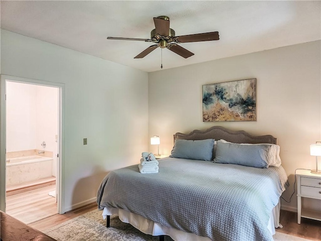 bedroom featuring ensuite bath, ceiling fan, and light hardwood / wood-style flooring