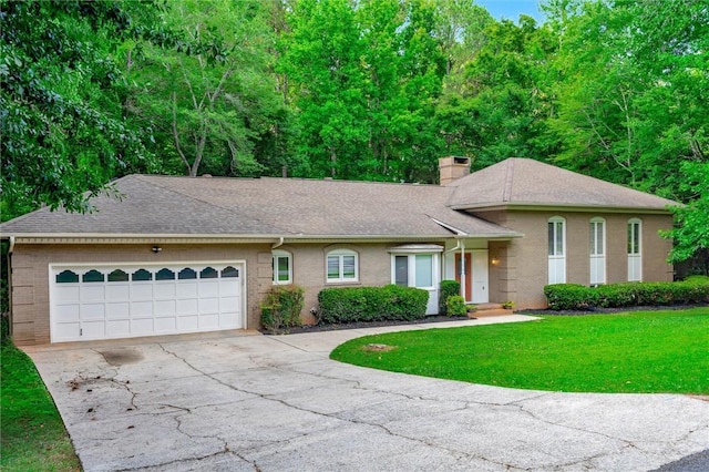 view of front of property with a garage and a front lawn