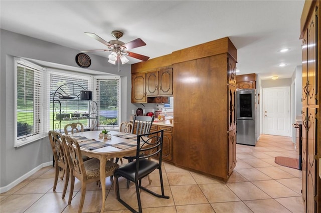 tiled dining area with ceiling fan