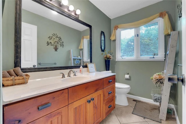 bathroom with toilet, tile patterned floors, and vanity