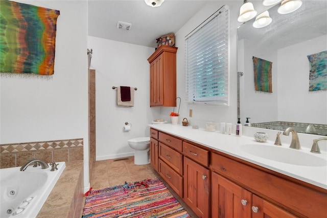 bathroom featuring tiled bath, toilet, tile patterned floors, and vanity