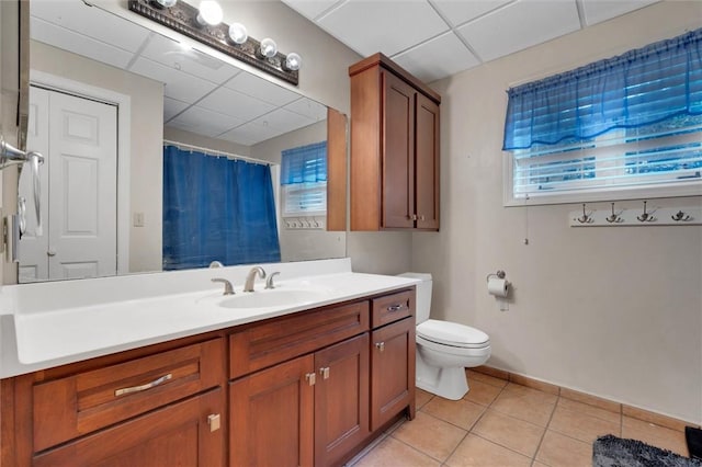 bathroom with toilet, vanity, tile patterned floors, a paneled ceiling, and a shower with shower curtain