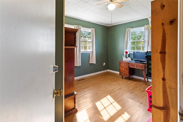 home office with ceiling fan and light hardwood / wood-style flooring