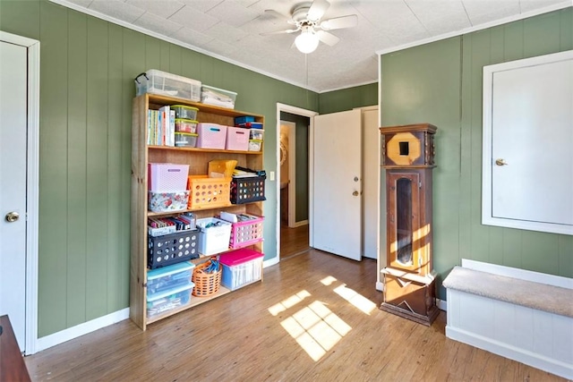 interior space featuring ceiling fan, ornamental molding, and hardwood / wood-style flooring