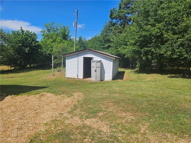 view of outbuilding featuring a yard