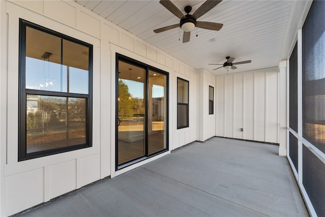 unfurnished sunroom featuring ceiling fan