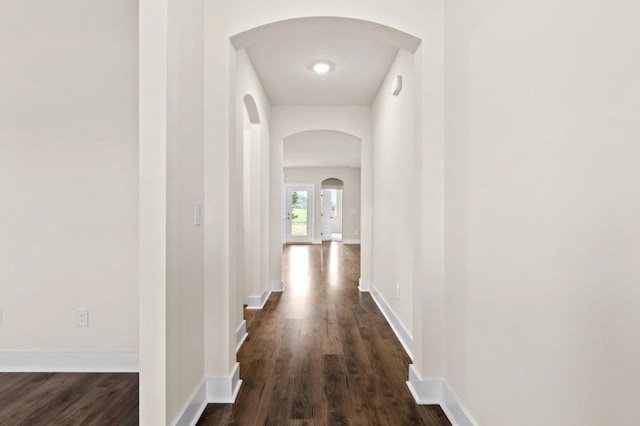 hallway with dark hardwood / wood-style flooring