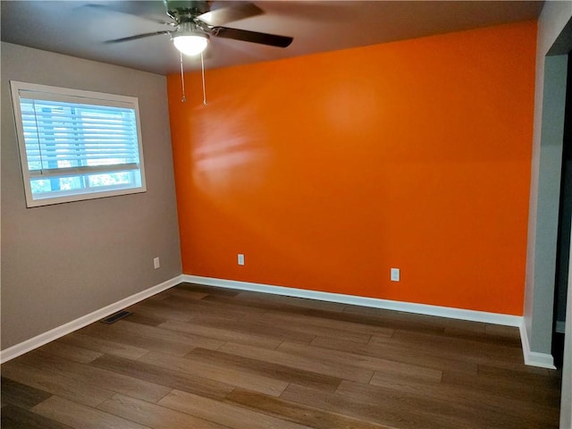 spare room with hardwood / wood-style flooring and ceiling fan