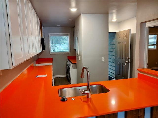 kitchen with white cabinetry, plenty of natural light, and sink