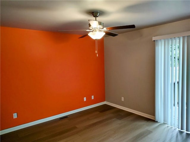 unfurnished room with dark hardwood / wood-style floors and ceiling fan