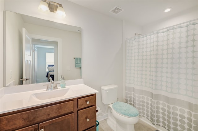 bathroom featuring a shower with curtain, vanity, toilet, and tile patterned floors