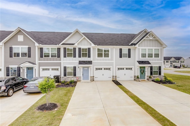 townhome / multi-family property featuring a garage and a front yard