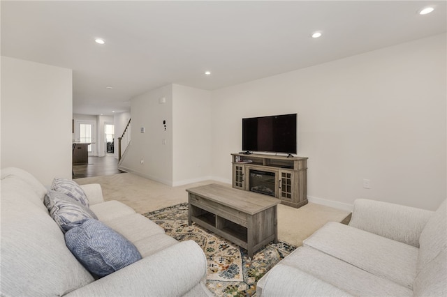 carpeted living room featuring a fireplace