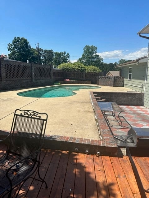 view of swimming pool with a deck and a patio