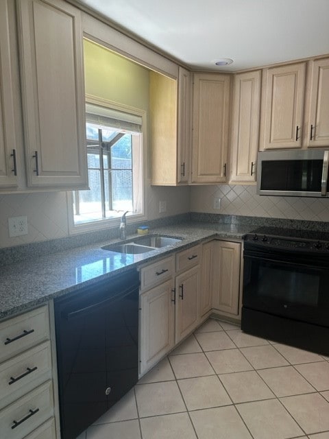 kitchen with light brown cabinets, sink, tasteful backsplash, light tile patterned floors, and black appliances