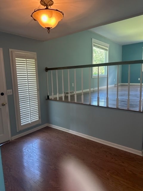 empty room with dark wood-type flooring