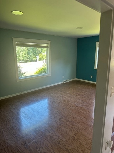 empty room featuring dark hardwood / wood-style flooring