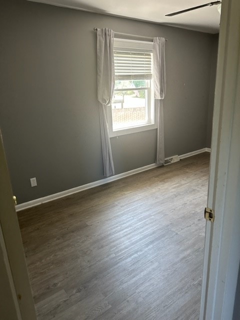 unfurnished room featuring wood-type flooring