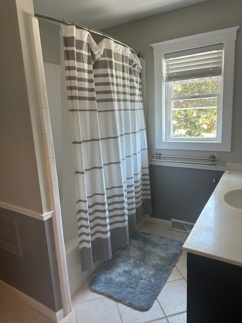 bathroom with shower / bath combination with curtain, vanity, and tile patterned floors