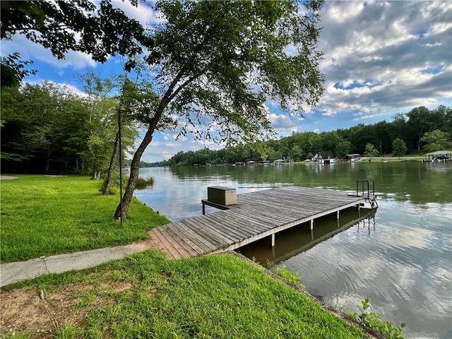 dock area with a lawn and a water view