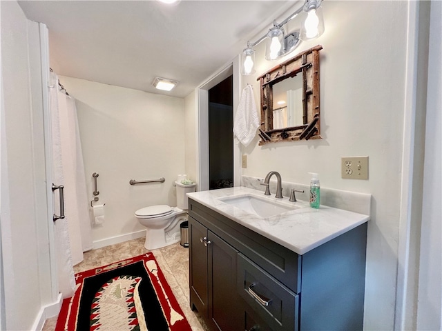 bathroom featuring tile patterned flooring, vanity, and toilet