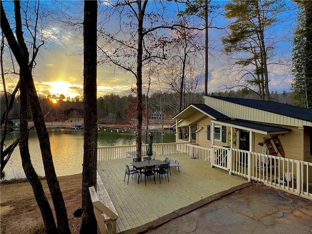 patio terrace at dusk with a deck with water view