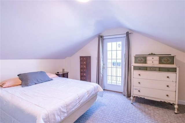 bedroom featuring lofted ceiling and light carpet