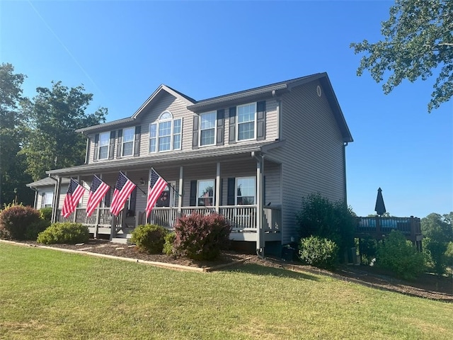 view of front facade with covered porch and a front yard