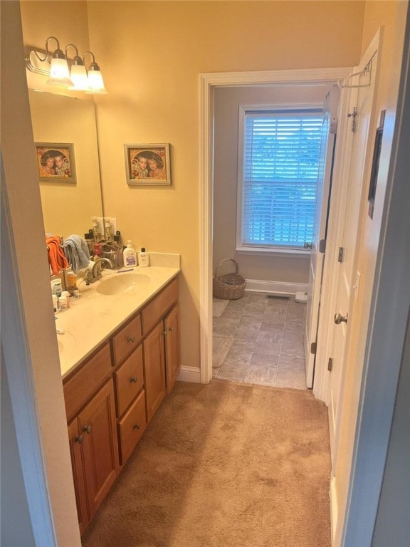 bathroom featuring tile patterned flooring, vanity, and toilet