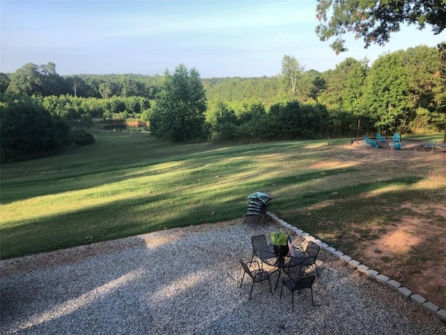 view of yard with a view of trees
