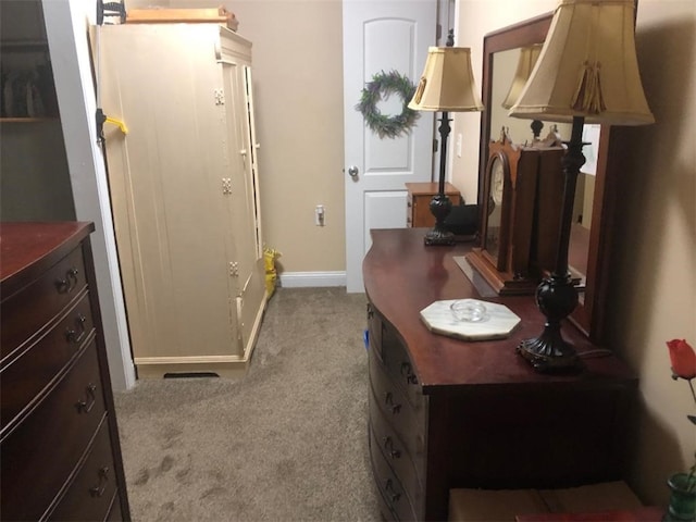 doorway to outside with carpet floors and baseboards
