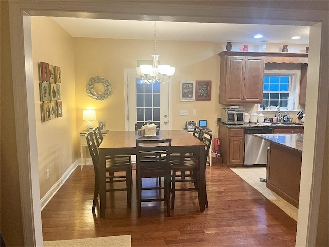 dining space featuring recessed lighting, dark wood-style flooring, baseboards, and a notable chandelier