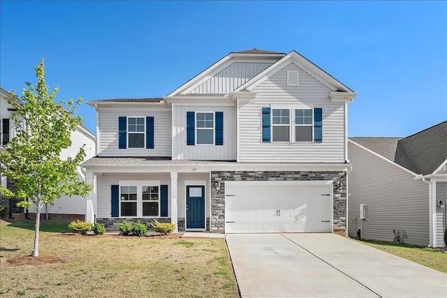 view of front of home with a front yard and a garage