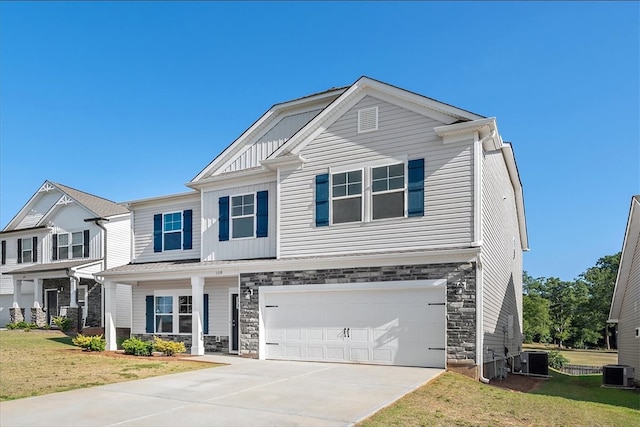 view of front of house featuring cooling unit, a garage, and a front lawn