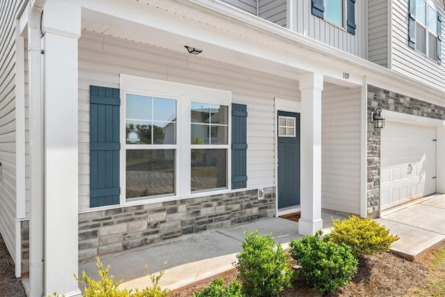 doorway to property featuring a garage and covered porch