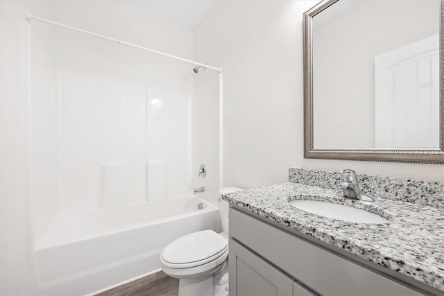 full bathroom featuring shower / washtub combination, hardwood / wood-style floors, vanity, and toilet