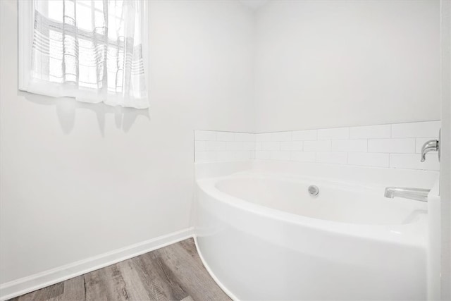 bathroom featuring a bathing tub and hardwood / wood-style floors