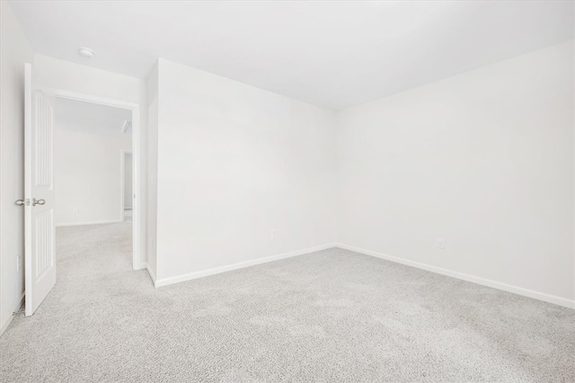 empty room with light colored carpet