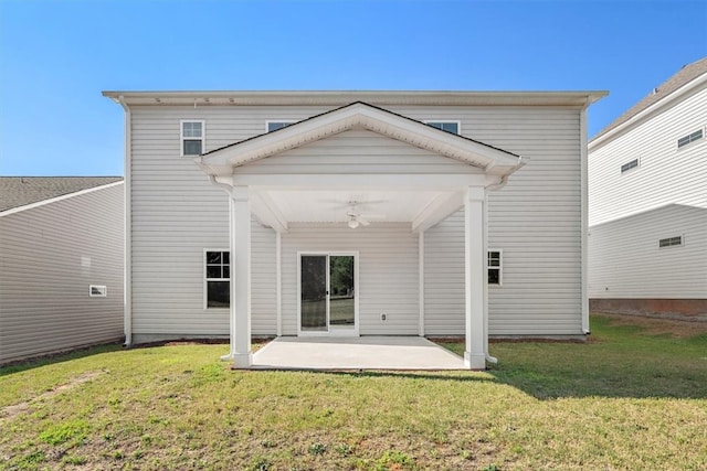 rear view of property featuring a patio area and a yard