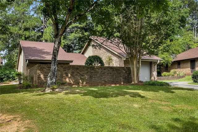 view of front of property with a garage and a front yard