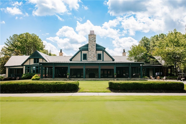 rear view of house featuring a yard