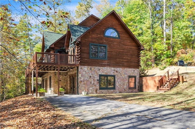 view of property exterior with a wooden deck