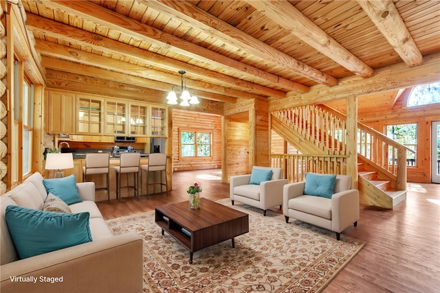 living room with wood ceiling, beam ceiling, light wood-type flooring, and a chandelier