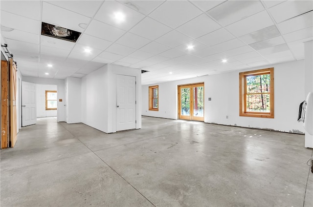 interior space featuring a drop ceiling and a barn door