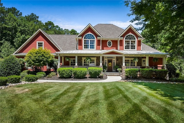 craftsman inspired home with a porch and a front lawn